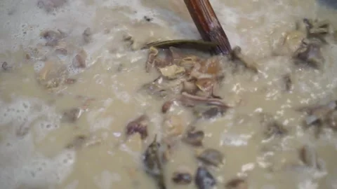 Lamb curry, cooking over fire, hot until boiling in large pan, authentic detail Stock Footage 293179118