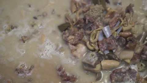 Lamb curry, cooking over fire, hot until boiling in large pan, authentic detail Stock Footage 293179230