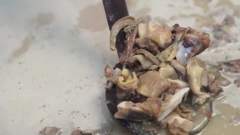 Lamb curry, cooking over fire, hot until boiling in large pan, authentic detail Stock Footage 293179237