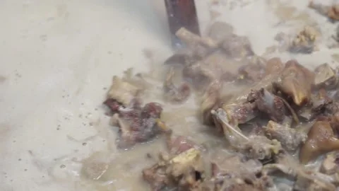 Lamb curry, cooking over fire, hot until boiling in large pan, authentic detail Stock Footage 293179253