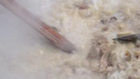 Lamb curry, cooking over fire, hot until boiling in large pan, authentic detail Stock Footage 293179305