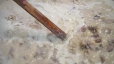 Lamb curry, cooking over fire, hot until boiling in large pan, authentic detail Stock Footage 293179319