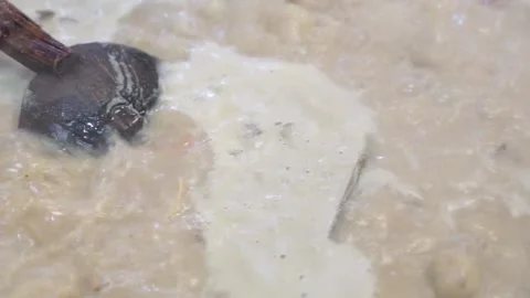 Lamb curry, cooking over fire, hot until boiling in large pan, authentic detail Stock Footage 293179369