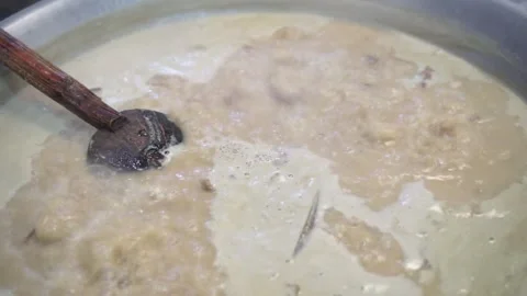 Lamb curry, cooking over fire, hot until boiling in large pan, authentic detail Stock Footage 293179382