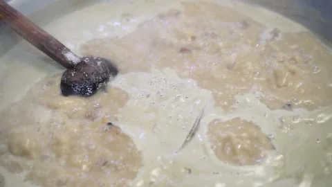 Lamb curry, cooking over fire, hot until boiling in large pan, authentic detail Stock Footage 293179426