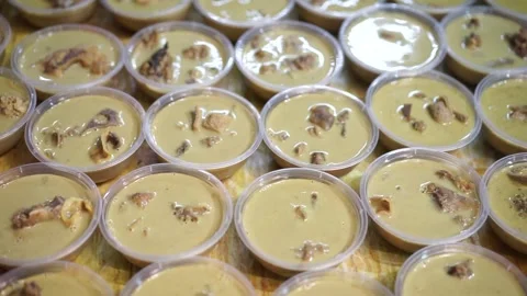 Lamb curry, serving in plastic cups for customers on the table, authentic detail Stock Footage 293180208