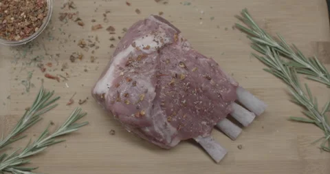 Lamb cut sprinkled with spices on the table Stock Footage 146387028