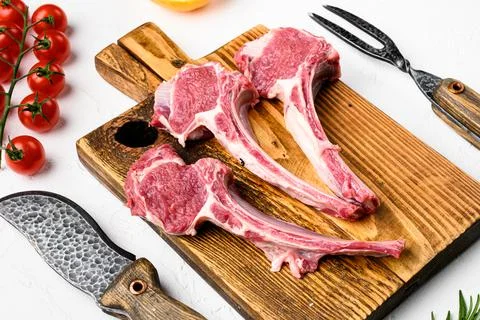 Lamb cutlets chops or mutton meat, on white stone table background Stock Photos