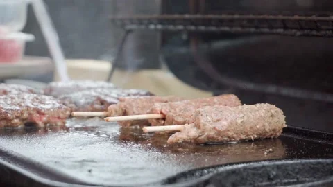 Lamb Kebabs Being Placed on Barbeque Stock Footage 240086639