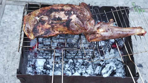 Lamb Leg Cooking Over Hot Coals on Charcoal Grill 動画素材 345355288