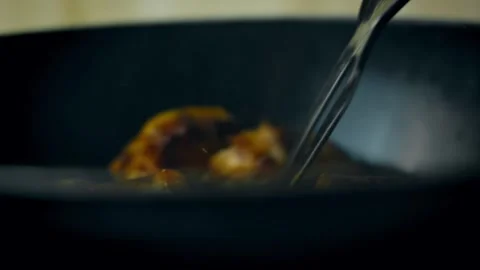 Lamb meat being turned to cook evenly in cooking pot Video stock 331639199