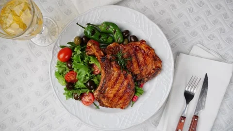 Lamb pork chops grilled fresh salad on plate  rotate. Loin on ribs. Top view Stock Footage 263317306