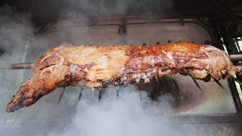 Lamb roasted in the oven. Some meat skewers being grilled. Lamb on skewer Video stock 196006031