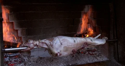 Lamb roasting and grilling on a spit at restaurant in Croatia, 4K Stock Footage 79174698
