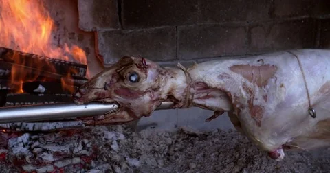 Lamb roasting and grilling on a spit at restaurant, hospitality in Croatia, 4K Stock Footage 79175026