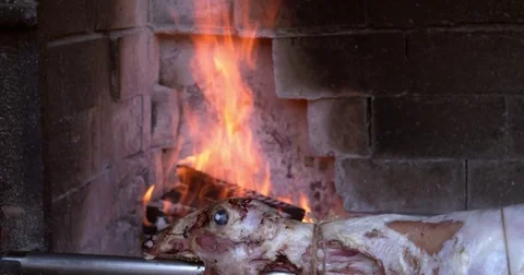 Lamb roasting and grilling on a spit at restaurant, hospitality in Croatia, 4K Stock Footage 79175328