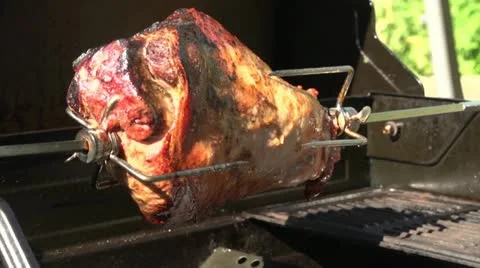 Lamb rotating on barbecue spit Stock Footage 20803334