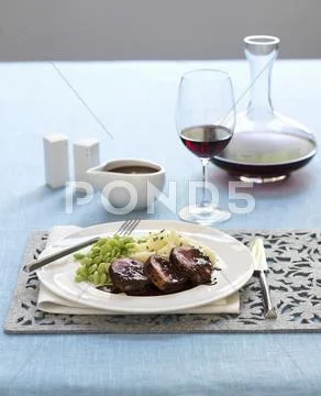 Lamb shoulder with chocolate sauce, mashed potatoes and lima beans Stock Photos