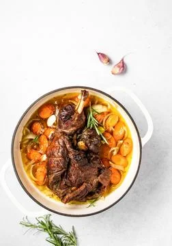 Lamb shoulder slow cooked  in a cast iron pan Stock Photos