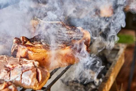 Lamb steaks are cooked on the grill for serving in catering Stock Photos