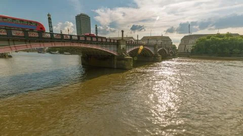 The Lambeth Bridge over the river Thames with red London buses Stock Photos