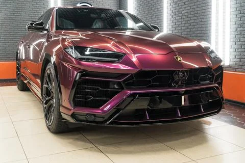 Lamborghini Urus in violet PPF is a high performance luxury SUV car. Stock Photos