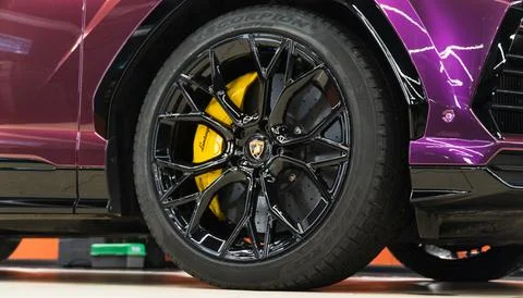 Lamborghini Urus in violet PPF is a high performance luxury SUV car. Stock Photos