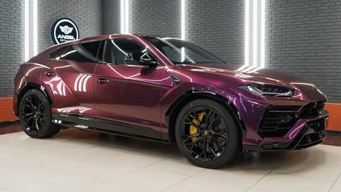 Lamborghini Urus in violet PPF is a high performance luxury SUV car. Stock Photos