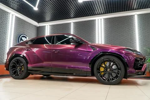 Lamborghini Urus in violet PPF is a high performance luxury SUV car. Stock Photos