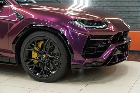 Lamborghini Urus in violet PPF is a high performance luxury SUV car. Stock Photos