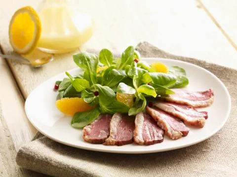 Lambs lettuce with duck breast Stock Photos