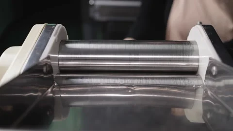 Laminated dough on the dough sheeter machine. Stock Footage 231807125