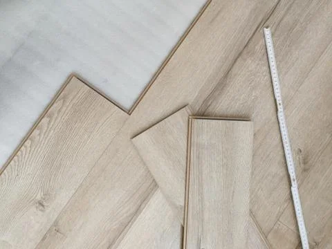 Laminated flooring under construction process. Home renewal concept Stock Photos