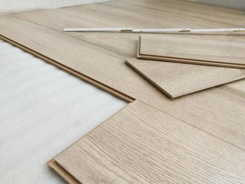 Laminated flooring under construction process. Home renewal concept Stock Photos