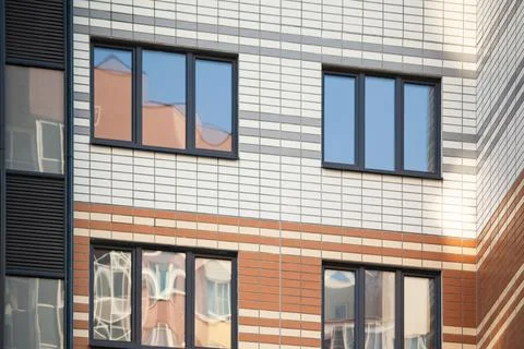 Laminated plastic windows on the facade of apartment buildings Stock Photos