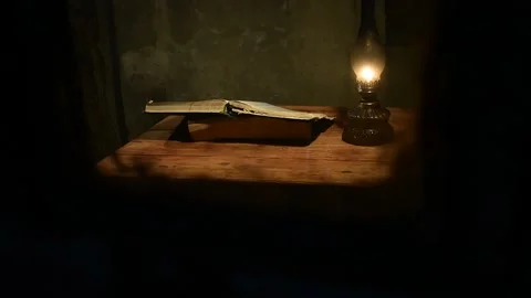 Lamp and a large book on the table, view through the window Stock Footage 135380497