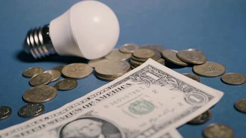 A lamp and money on a yellow background with copy space. Stock Footage 318920249