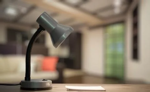 Lamp and notebook on table Stock Photos