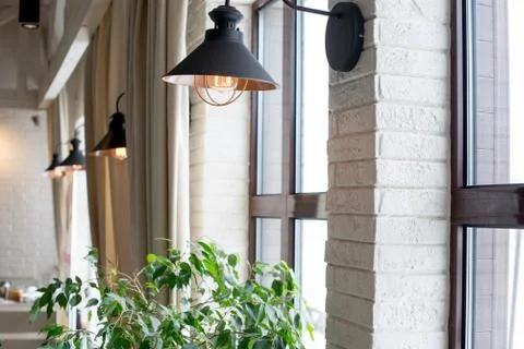 A lamp on the background of a window and a wall with curtains Foto stock