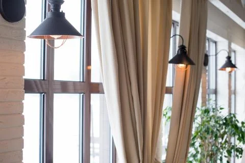 A lamp on the background of a window and a wall with curtains Foto stock