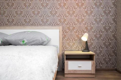 Lamp on the bedside table in the bedroom Stock Photos