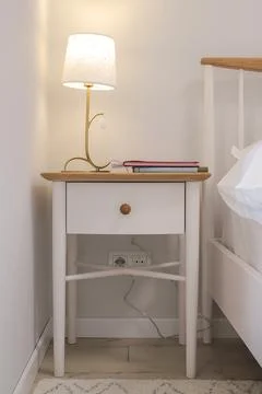 Lamp on the bedside table in the bedroom Stock Photos