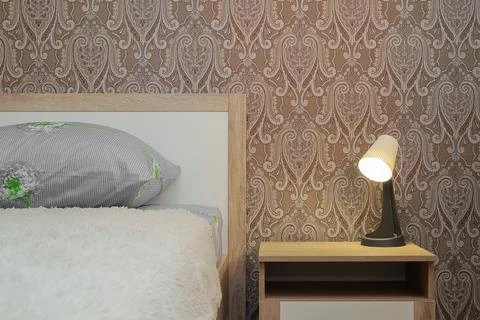 Lamp on the bedside table in the bedroom Stock Photos