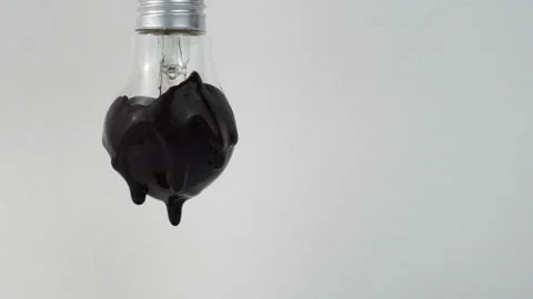 Lamp in black paint on grey background. The black paint drips. Stock Footage 89741745