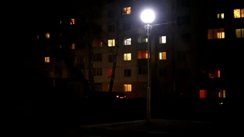 Lamp blinks in the night city. Electricity problems. Old lamp on the street Stock Footage