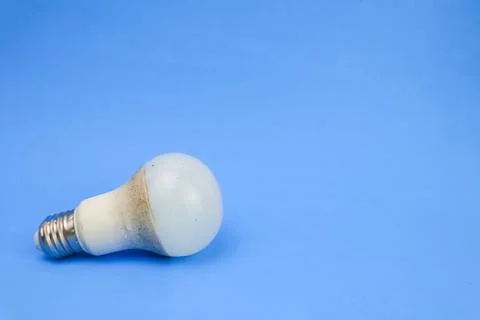 A lamp on a blue background. Stock Photos