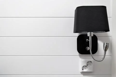 Lamp-bracket on a white wall. Stock Photos