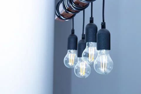 The lamp on the ceiling of the light bulbs located on the wires. Stock Photos