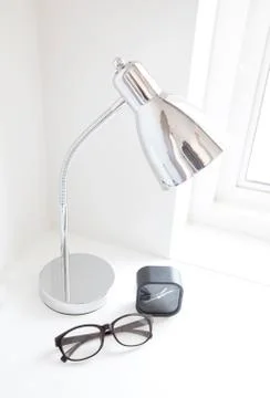 Lamp, clock and watches on the table. Stock Photos