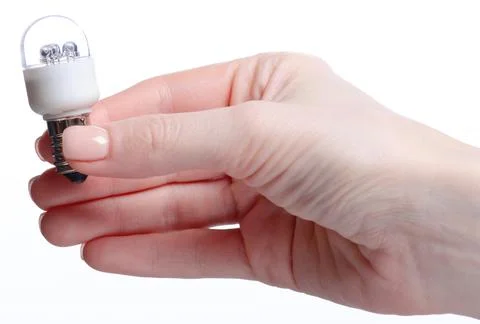 Lamp E14 energy-saving compact fluorescent in hand Stock Photos